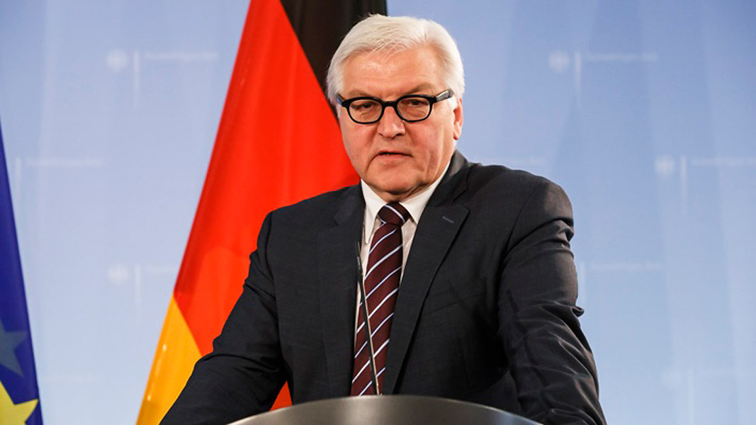 Frank-Walter Steinmeier speaking at a lectern in front of German and European flags