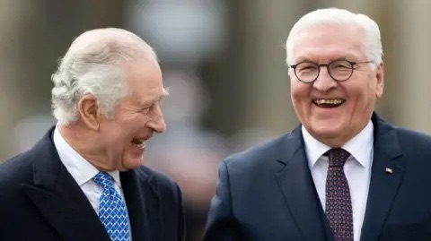 King Charles III and Frank-Walter Steinmeier laughing together outdoors in Berlin