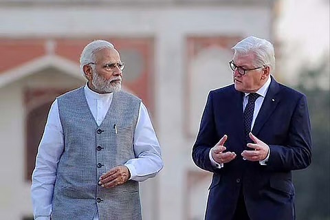 Prime Minister Narendra Modi and Frank-Walter Steinmeier walking and talking outdoors